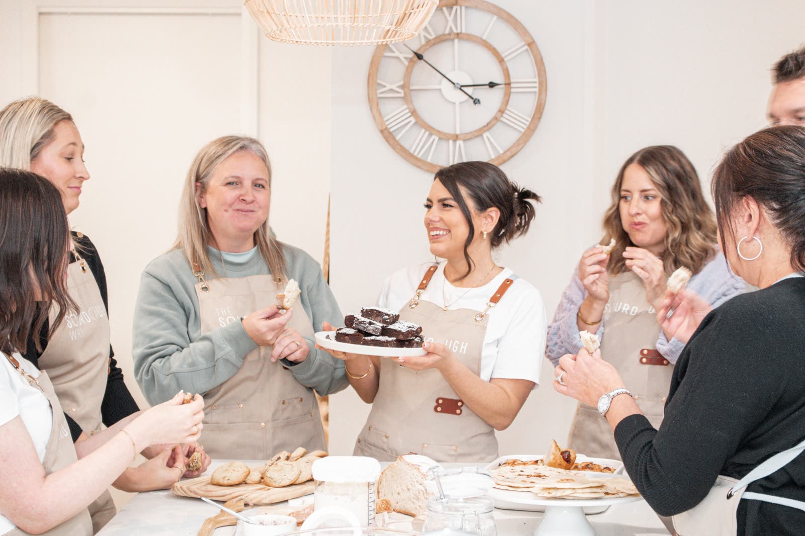 Sourdough workshop group sharing brownies and bread