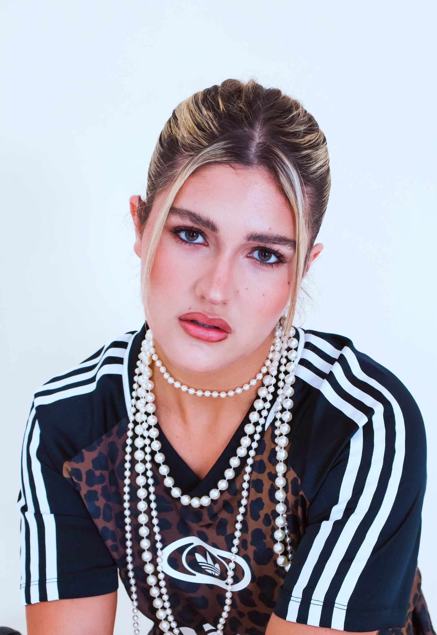 Close studio portrait with layered pearl necklaces